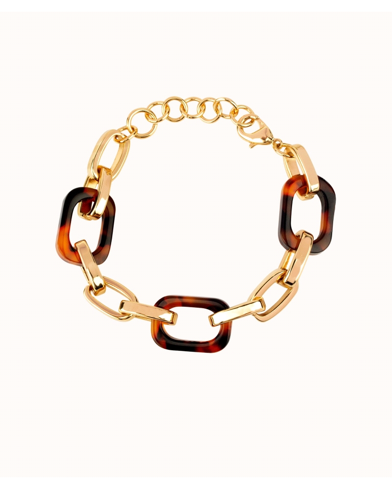 Pulsera chapada en oro 18 Kt con eslabones de acetato estilo carey. Medida 18 cm + 4 cm de cadena ajustable. El complemento perf